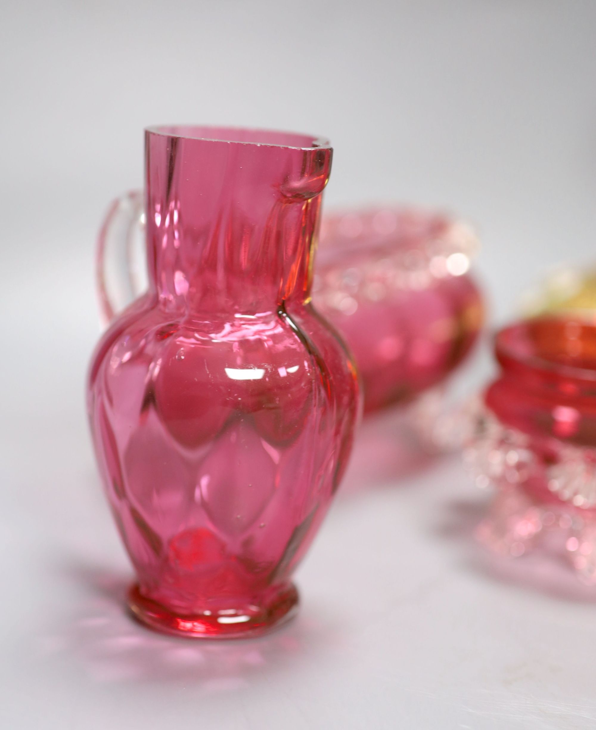 Six pieces of cranberry glass and a later bohemian ashtray, tallest 21cm